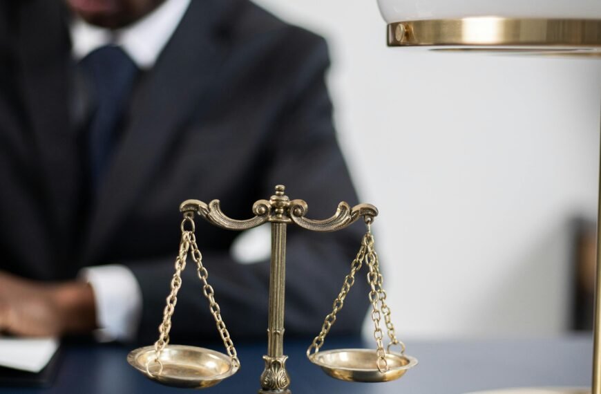 A professional lawyer working at his desk with scales of justice symbolizing fairness and law competence.